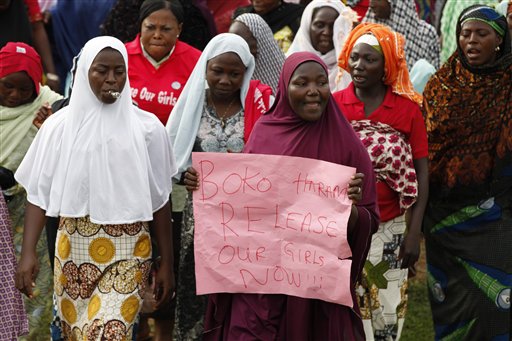 Women sing slogans during a demonstration calling on the government to rescue the kidnapped girls of the government secondary school in Chibok, in Abuja, Nigeria, Wednesday, May 28, 2014. Apparent disagreement has emerged between Nigerias military chiefs and the president over how to rescue nearly 300 schoolgirls abducted by Islamic extremists, with the military saying use of force could get the hostages killed and the president reportedly ruling out demands for a prisoner exchange.   (AP Photo/Sunday Alamba)
