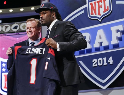 South Carolina defensive end Jadeveon Clowney holds up the jersey for the Houston Texans first pick of the first round of the 2014 NFL Draft with NFL commissioner Roger Goddell, Thursday, May 8, 2014, in New York. (AP Photo/Craig Ruttle)
