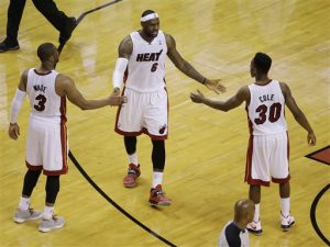 Miami Heat forward LeBron James (6) congratulates guards Norris Cole (30) and Dwyane Wade (3) during the second half of Game 4 in the NBA basketball Eastern Conference finals playoff series, Monday, May 26, 2014, in Miami. The Heat defeated the Pacers 102-90. (AP Photo/Lynne Sladky)