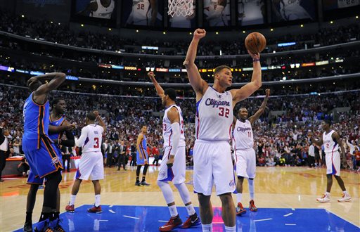 Los Angeles Clippers forward Blake Griffin, center, celebrates along with members of his team as Oklahoma City Thunder forward Serge Ibaka, left, of Congo, and center Ryan Hollins look on as the Clippers win Game 4 of the Western Conference semifinal NBA basketball playoff series, Sunday, May 11, 2014, in Los Angeles. The Clippers won 101-99. (AP Photo/Mark J. Terrill)