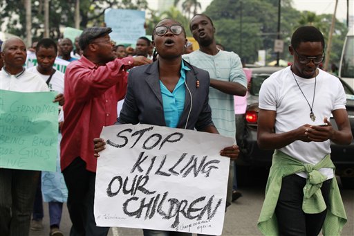 People attend a demonstration calling on  government to rescue kidnapped school girls of a government secondary school Chibok, during workers day celebration in Lagos, Nigeria. (AP Photo/ Sunday Alamba)