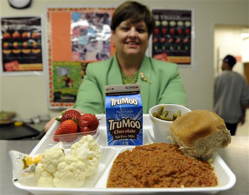 In this Tuesday, April 29, 2014 photo, Becky Domokos-Bays, the director of food and nutrition services at Alexandria City Public Schools, holds up a tray of food during lunch at the Patrick Henry Elementary School in Alexandria, Va. Starting next school year, pasta and other grain products in schools will have to be whole-grain rich, or more than half whole grain. The requirement is part of a government effort to make school lunches and breakfasts healthier. (AP Photo/Susan Walsh)