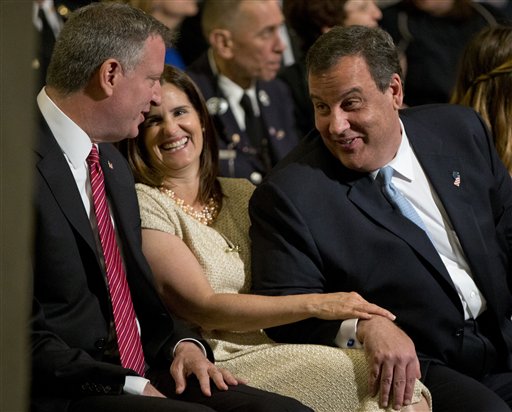New York City Mayor Bill de Blasio, left, talks with New Jersey Gov. Chris Christie, right, and his wife Mary Pat Foster, before a ceremony at the National September 11 Memorial Museum, Thursday, May 15, 2014, in New York. The museum is a monument to how the Sept. 11 terror attacks shaped history, from its heart-wrenching artifacts to the underground space that houses them amid the remnants of the fallen twin towers' foundations. It also reflects the complexity of crafting a public understanding of the terrorist attacks and reconceiving ground zero.  (AP Photo/Carolyn Kaster)