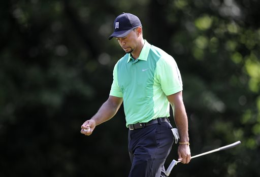 Tiger Woods walks off the 16th green during the first round of the Quicken Loans National golf tournament, Thursday, June 26, 2014, in Bethesda, Md. (AP Photo/Nick Wass)