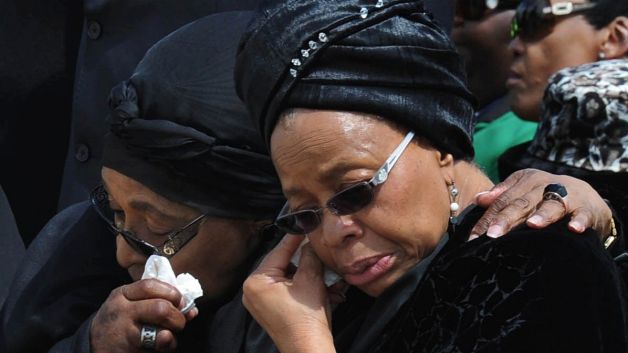 Mandela's widow, Graça Machel (right) and Winnie Madikizela-Mandela embrace at Nelson Mandela's funeral. (Kopano Tlape, CGIS/AP Photo)