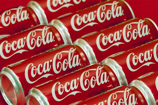 This July 15, 2013 file photo shows cans of Coca-Cola in Doral, Fla. Coca-Cola is taking on obesity, this time with an online video showing how fun it could be to burn off the 140 calories in a can of its soda. (AP Photo/Wilfredo Lee, File)