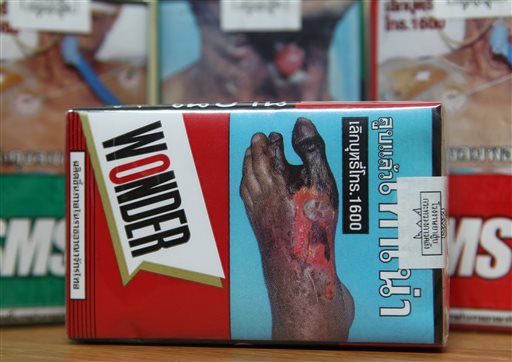 Warning signs on cigarette packets in Bangkok. (AP Photo/Apichart Weerawong, File)