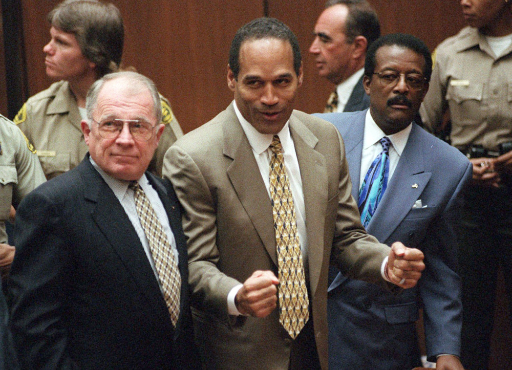 O.J. Simpson reacts as he is found not guilty of murder in Los Angeles on Oct. 3, 1995. At left is defense lawyer F. Lee Bailey and at right is defense attorney Johnnie Cochran Jr. (AP Photo)
