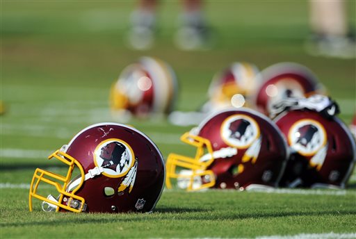 In this June 17, 2014, file photo, Washington Redskins helmets sit on the field during an NFL football minicamp in Ashburn, Va. The U.S. Patent Office ruled Wednesday, June 18, 2014, that the Washington Redskins nickname is "disparaging of Native Americans" and that the team's federal trademarks for the name must be canceled. The ruling comes after a campaign to change the name has gained momentum over the past year. (AP Photo/Nick Wass, File)