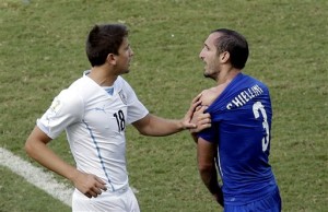 Italy's Giorgio Chiellini (3) complains after Uruguay's Luis Suarez ran into his shoulder with his teeth during the group D World Cup soccer match between Italy and Uruguay at the Arena das Dunas in Natal, Brazil, Tuesday, June 24, 2014. (AP Photo/Hassan Ammar)