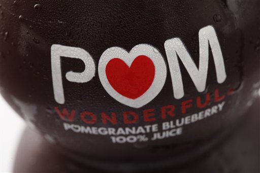 This Sept. 27, 2010 file photo shows a bottle of POM Wonderful juice in Philadelphia. The Supreme Court on Thursday sided with juice maker Pom Wonderful in its long-running false advertising dispute with Coca Cola, a decision that could open the door to more litigation against food makers for deceptive labeling. The justices ruled 8-0 that Pom can go forward with a lawsuit alleging the label on a "Pomegranate Blueberry" beverage offered by Coke's Minute Maid unit is misleading because 99 percent of the drink consists of apple and grape juice. (AP Photo/Matt Rourke, File)