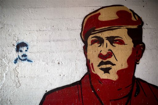 In this Feb. 19, 2014 file photo, a large mural of Venezuela's late President Hugo Chavez, right, is placed next to a small stencil of current President Nicolas Maduro on a wall in downtown Caracas, Venezuela. Charges from old-school leftists that Maduro is mishandling Chavezs legacy have the potential to do real damage. The former bus driver and union leader squeaked out a narrow electoral victory by riding the tide of admiration and mourning that followed Chavezs death from cancer last year. (AP Photo/Rodrigo Abd, File)
