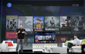 Dave Burke, director of engineering at Android, left, speaks about Android TV during the Google I/O 2014 keynote presentation in San Francisco, Wednesday, June 25, 2014. As the Internet giant's Android operating system stretches into cars, homes and smartwatches, this year's annual confab will expand on its usual focus on smartphones and tablets. (AP Photo/Jeff Chiu)