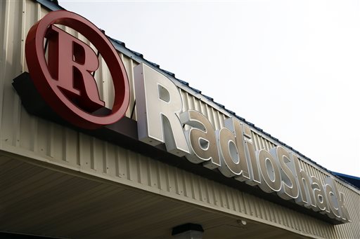 This March 25, 2014 photo shows a RadioShack store sign in Philadelphia. RadioShack on Tuesday, June 10, 2014 reported its first-quarter loss widened and revenue slumped as the retailer dealt with weakness in its mobile business and consumer electronics. (AP Photo/Matt Rourke)