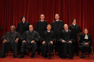 Chief Justice John Roberts is shown (front row, center) with the Associate Justices (back row) Sonia Sotomayor, Stephen Breyer, Samuel Alito Jr., (front row) Clarence Thomas, Antonin Scalia, Anthony Kennedy and Ruth Bader Ginsburg. (AP Photo/Pablo Martinez Monsivais).