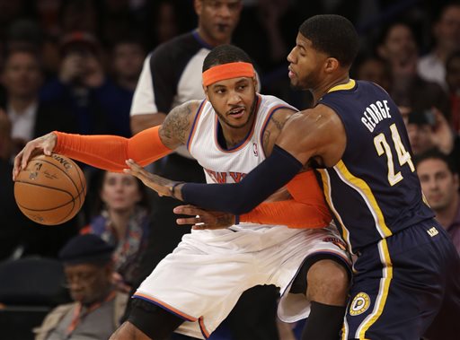 In this March 19, 2014, file photo, New York Knicks' Carmelo Anthony, left, tries to move around Indiana Pacers' Paul George during the first half of an NBA basketball game at Madison Square Garden in New York. Two people with knowledge of the details say that Anthony has informed the Knicks he intends to become a free agent. (AP Photo/Seth Wenig, File)
