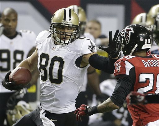 In this Nov. 21, 2013 file photo, New Orleans Saints tight end Jimmy Graham (80) tries to get past Atlanta Falcons free safety Thomas DeCoud (28) during the second half of an NFL football game in Atlanta. An arbitrator has sided with the Saints in ruling that Graham can only be considered a tight end for the purposes of his franchise tag designation. The ruling Wednesday, July 2, 2014, by Stephen Burbank is setback for Graham, agent Jimmy Sexton and the NFL Players Association, who'd filed a grievance arguing that Graham was used as a wide receiver often enough to qualify for the more lucrative receiver tag. (AP Photo/John Bazemore, File)