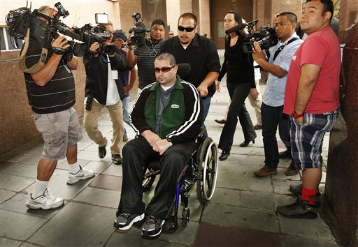 FILE - This June 25, 2014 file photo shows a wheelchair bound Bryan Stow surrounded by family and media as he is led into the Los Angeles County Superior Courthouse in Los Angeles. Stow has won his negligence suit against the Los Angeles Dodgers, but former owner Frank McCourt has been absolved by the jury.(AP Photo/Los Angeles Times, Al Seib,File) NO FORNS; NO SALES; MAGS OUT; ORANGE COUNTY REGISTER OUT; LOS ANGELES DAILY NEWS OUT; INLAND VALLEY DAILY BULLETIN OUT; MANDATORY CREDIT, TV OUT