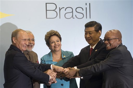 Leaders of the BRICS nations, from left, Russia's President Vladimir Putin, India's Prime Minister Narendra Modi, Brazil's President Dilma Rousseff, China's President Xi Jinping and South Africa's President Jacob Zuma, pose for a group photo during the BRICS summit in Fortaleza, Brazil, Tuesday, July 15, 2014. The leaders of the BRICS nations are expected to officially create a bailout and development fund worth $100 billion. It's meant to be an alternative to the World Bank and the International Monetary Fund, which are seen as being dominated by the U.S. and Europe. (AP Photo/Silvia Izquierdo)