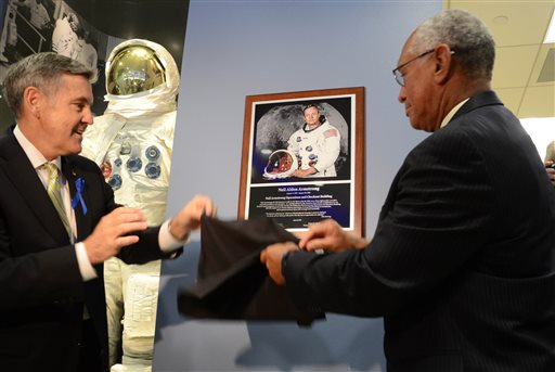 Kennedy Space Center Director Robert Cabana, left, and NASA Administrator Charles Bolden unveil a plaque of astronaut Neil Armstrong,  the first man to walk on the moon, in the Operations and Checkout building at Kennedy Space Center, Fla., during a ceremony to rename the building in Armstrong's honor, Monday, July 21, 2014. The building was renamed for Apollo astronaut Neil Armstrong.  (AP Photo, Florida Today, Craig Bailey)