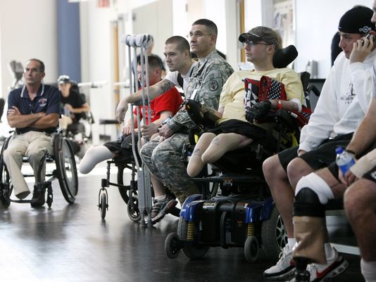 In this Nov. 8, 2007 file photo, wounded soldiers involved in physical therapy wait for President Bush to visit a physical therapy lab for wounded soldiers at the Center For The Intrepid at the Brooke Army Medical Center in San Antonio. (Gerald Herbert, AP)