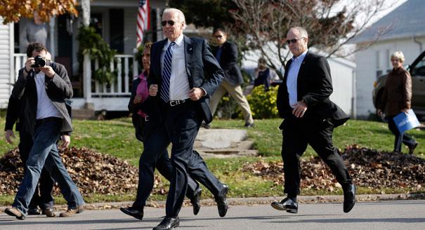 Biden runs across the street from a campaign stop to meet students outside two schools in Muscatine, Iowa. (AP Photo)