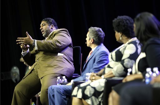 William Barber, left, speaks during a panel discussion on black turnout for midterm elections and voter suppression during the NAACP annual convention Tuesday, July 22, 2014, in Las Vegas. (AP Photo/John Locher)