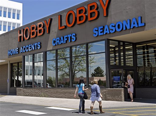 In this May 22, 2013, customers enter and exit a Hobby Lobby store in Denver. The Supreme Court is poised to deliver its verdict in a case that weighs the religious rights of employers and the right of women to the birth control of their choice. Employers must cover contraception for women at no extra charge among a range of preventive benefits in employee health plans. Dozens of companies, including the arts and crafts chain Hobby Lobby, claim religious objections to covering some or all contraceptives. (AP Photo/Ed Andrieski, File)