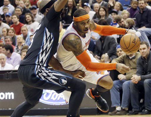 In this March 5, 2014, file photo, New York Knicks' Carmelo Anthony, right, leaves the floor as he drives around Minnesota Timberwolves' Dante Cunningham in the second half of an NBA basketball game in Minneapolis. A person with knowledge of the plans says the Knicks plan to meet with Anthony on Thursday, July 3, 2014, in Los Angeles. Anthony was in Los Angeles to meet with the Lakers, who are among the teams hoping to convince the All-Star forward to leave New York. (AP Photo/Jim Mone, File)