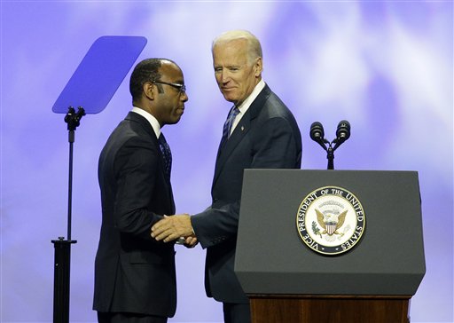 Vice President Joe Biden, right, shakes hands with NAACP President and CEO Cornell William Brooks at the NAACP annual convention Wednesday, July 23, 2014, in Las Vegas. Biden called on members of the NAACP to spread the word about what he called "a hailstorm" of measures to restrict citizens ability to vote, trying to rally the Democratic Party's base before the midterm elections. (AP Photo/John Locher)