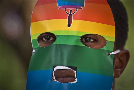 In this Feb. 10, 2014 file photo, a Kenyan gay wears a mask to preserve his anonymity as they stage a rare protest, against Uganda's increasingly tough stance against homosexuality outside the Uganda High Commission in Nairobi, Kenya. Human rights and gay rights activists on Tuesday, July 29, 2014, urged President Barack Obama to ensure that the issue of anti-gay discrimination in Africa is on the agenda at next week's summit in Washington with more than 40 African leaders. (AP Photo/Ben Curtis, File)
