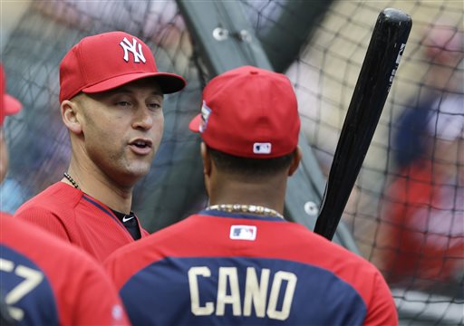 American League shortstop Derek Jeter, of the New York Yankees, left, talks with teammate second baseman Robinson Cano, of the Seattle Mariners, during batting practice for the MLB All-Star baseball game, Monday, July 14, 2014, in Minneapolis. (AP Photo/Jeff Roberson)