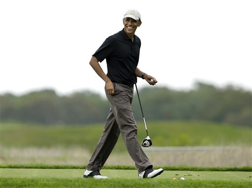 This Aug. 12, 2013, file photo shows President Barack Obama as he steps onto a tee while golfing at Vineyard Golf Club in Edgartown, Mass., on the island of Martha's Vineyard, during his vacation. Obama is doing something unusual with his summer vacation on Marthas Vineyard: Hell come back to Washington midway through the getaway to attend White House meetings.  (AP Photo/Steven Senne, File)