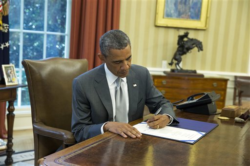 President Barack Obama signs "H.J. Res. 76," a bill that provides an additional $225 million in U.S. taxpayer dollars for Israel's Iron Dome missile defense system, in the Oval Office of the White House, Monday, Aug. 4, 2014, in Washington. (AP Photo/ Evan Vucci)