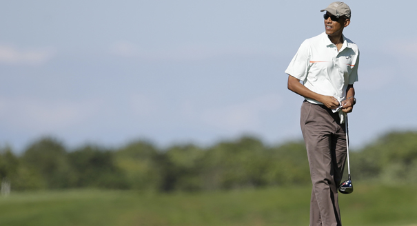 President Barack Obama prepares to tee off while golfing at Vineyard Golf Club, in Edgartown, Mass., on the island of Martha's Vineyard, Thursday, Aug. 14, 2014. President Obama is taking a two-week summer vacation on the island. (AP Photo/Steven Senne)