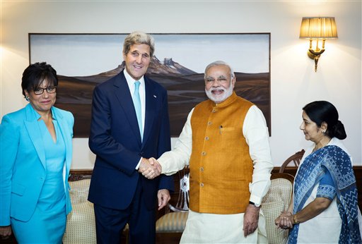 U.S. Secretary of State John Kerry shakes hands with Indian Prime Minister Narendra Modi, as Indian Foreign Minister Sushma Swaraj, right, and U.S. Secretary of Commerce Penny Pritzker stand by their sides at Modi's residence in New Delhi, India, Friday, Aug. 1, 2014. Kerry is on a three-day visit, his first following the resounding election win of Modi in May. (AP Photo/Lucas Jackson, Pool)