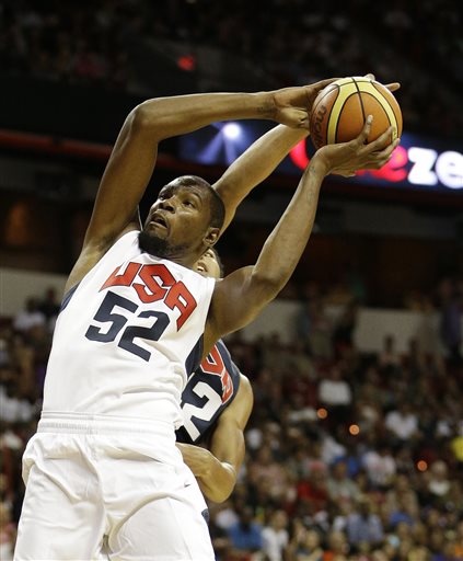 Oklahoma City Thunder's Kevin Durant (52) goes up for a dunk against New Orleans Pelicans' Anthony Davis (42) during the U.S. national team's instrasquad exhibition basketball game Friday, Aug. 1, 2014, in Las Vegas. (AP Photo/John Locher)