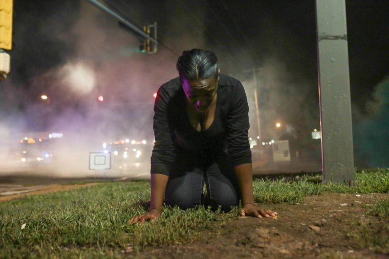 Peaceful protester gasping after being hit with tear gas by police (Lawrence Bryant/St. Louis American)