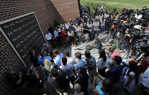 Baltimore Ravens running back Ray Rice, left, addressing the media at a news conference after NFL football training camp practice, Thursday, July 31, 2014, in Owings Mills, Md. (AP Photo/Gail Burton)