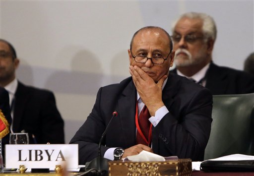 Libyan Foreign Minister Mohamed Abdelaziz, second left, attends a Cairo gathering of foreign ministers of Libya's neighbors in Cairo, Egypt, Monday, Aug. 25, 2014. Foreign ministers from Egypt Libya, Algeria, Tunisia, Sudan, and Chad, as well as the Arab League Secretary General, met Monday as weeks of inter-militia fighting has wreaked havoc in Libya. It's the worst violence in Libya since the 2011 downfall and killing of dictator Moammar Gadhafi. (AP Photo/Amr Nabil)