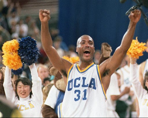 In this April 3, 1995 photo, UCLA's Ed O'Bannon celebrates after his team won the  championship NCAA game against Arkansas in Seattle. A federal judge has ruled that the NCAA can't stop college football and basketball players from selling the rights to their names and likenesses, opening the way to athletes getting payouts once their college careers are over, Friday, Aug. 8, 2014. (AP Photo/Eric Draper, File)