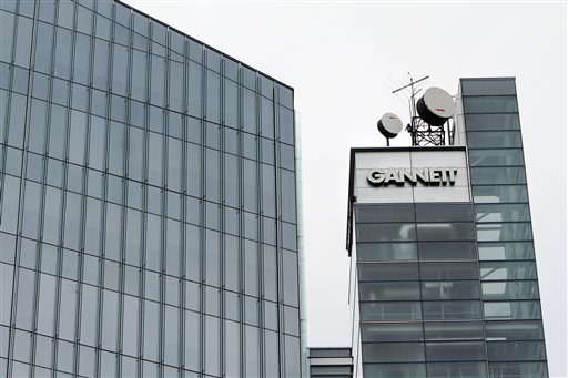 This July 14, 2010, file photo, shows Gannett headquarters in McLean, Va. Gannett is spinning off its publishing business from its broadcasting and digital operations. The company is also acquiring full ownership of Cars.com for $1.8 billion., the company announced Tuesday, Aug. 5, 2014. (AP Photo/Jacquelyn Martin, File)