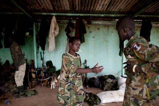 In this Friday, May 11, 2012 file photo, a young South Sudanese soldier who appeared to be drunk reaches for a lighter for his cigarette at the Sudan People's Liberation Army (SPLA) headquarters in Bentiu, Unity State, South Sudan. The U.N.'s top official for children and armed conflicts Leila Zerrougui said during a stop in Kenya on Thursday, Aug. 21, 2014 that the use of child soldiers and violence against children is commonplace in South Sudan's year of warfare. (AP Photo/Pete Muller, File)