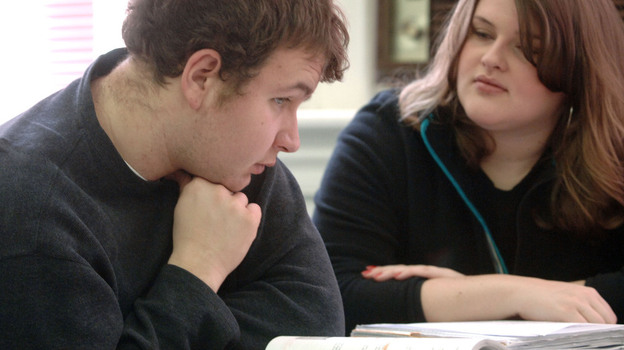 Lowell Austin, an autistic student at Marshall University in Huntington, W.Va., receives tutoring from Stephanie Hurly at the university's Autism Training Center, one of several college programs highlighted on the website College Autism Spectrum.