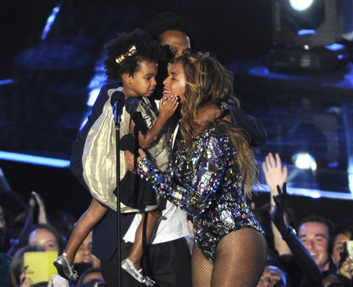 In this Sunday, Aug. 24, 2014 file photo, Beyonce on stage hugs Jay Z and their daughter Blue Ivy as she accepts the Video Vanguard Award at the MTV Video Music Awards at The Forum, in Inglewood, Calif. BET has suspended a producer after a joke about Blue Ivys hair aired Monday, Aug. 25, 2014, on the networks music video countdown show, 106 & Park. A source at the network, who spoke on the condition of anonymity because the person was not allowed to discuss the matter publicly, said the producer was suspended after the ill-fitting joke about Beyonce and Jay Zs two-year-old daughter aired. (Photo by Chris Pizzello/Invision/AP, file)