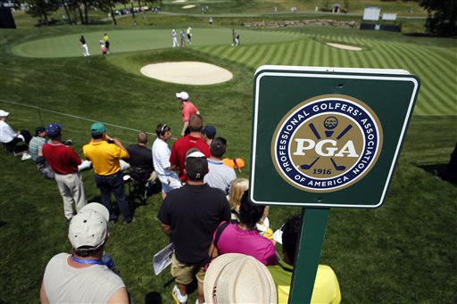 A few fans watch as golfers putt on the 16th green during a practice round at the PGA Championship golf tournament at Valhalla Golf Club Monday, Aug. 4, 2014, in Louisville, Ky. The tournament starts on Thursday. (AP Photo/Jeff Roberson)