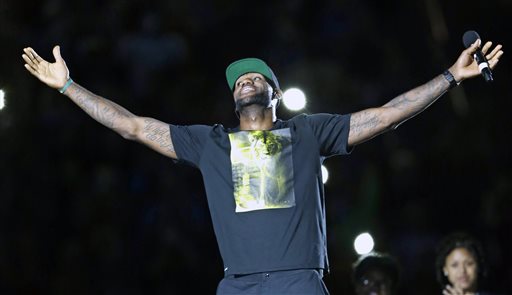 Cleveland Cavaliers' LeBron James smiles as he is introduced at his homecoming at InfoCision Stadium Friday, Aug. 8, 2014, in Akron, Ohio. (AP Photo/Tony Dejak)