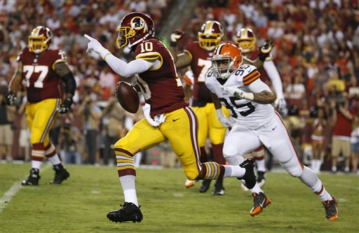 Washington Redskins quarterback Robert Griffin III (10) runs away from Cleveland Browns defensive end Armonty Bryant (95) during the first half of an NFL preseason football game Monday, Aug. 18, 2014, in Landover, Md. (AP Photo/Evan Vucci)