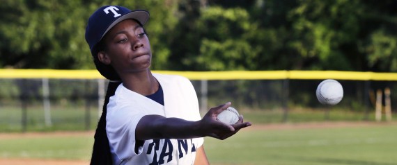 In this Aug. 6, 2014, photo, Pennsylvania's Mo'Ne Davis flips baseballs to a teammate prior to facing the District of Columbia in the Little League Eastern Regionals at Breen Stadium in Bristol, Conn. Davis and New Jersey's Kayla Roncin are competing to make it to the Little League World Series, a rare feat for girls.  (AP Photo/Charles Krupa)