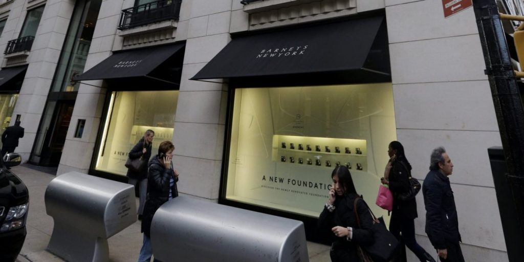 Pedestrians pass Barneys New York department store Monday, Oct. 28, 2013, in New York. The scenario usually involves suspicious glances, inattentive clerks or rude service _ not handcuffs. Yet when a black teen came forward with a story of being briefly jailed after buying a $350 belt at the Manhattan luxury store, it stirred up an age-old problem that many African-Americans still deal with today. (AP Photo/Frank Franklin II)
